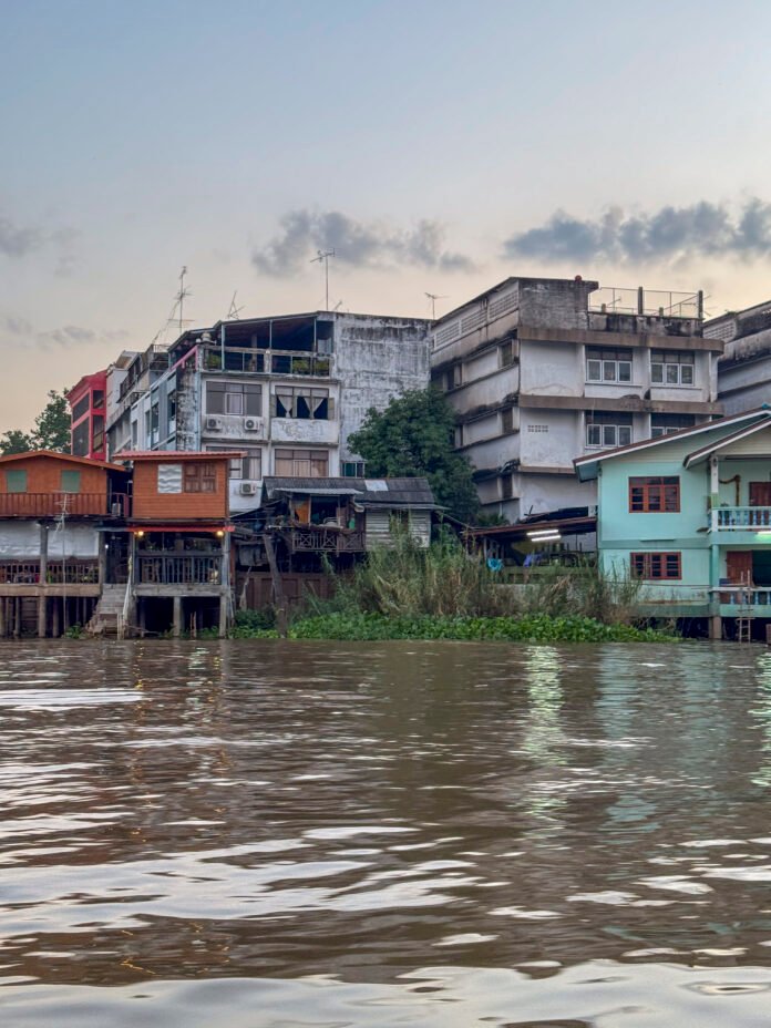 Serene wooden boat navigating on a peaceful murky water canal